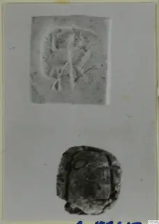 Seal impression above a dark stone seal, laid out on a grey card.