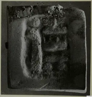 Seal or gem with a raised relief design, photographed on a grey ground