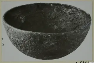 Deep rounded bowl with a rough, pitted dark surface, from Amathus