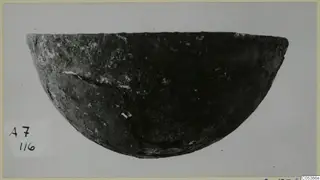 Dark, rounded bowl with a cracked side, photographed against a pale grey background from Amathus tombs 1-9