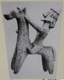 Clay figurine of a horse with a rider wearing a pointed cap, from Amathus tomb group 2-26