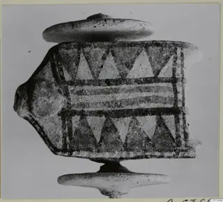 Painted object from Amathus with triangle and band decoration, photographed against a plain grey background