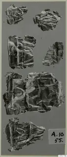 Several crumpled gold foil fragments from Amathus, tombs 10–26, laid out on a grey background.