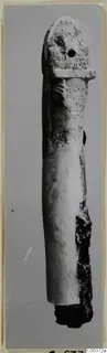 Long bone object from Amathus with a small hole near its rounded top, photographed upright