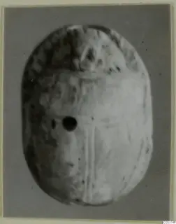 Oval object with a pierced hole and faint incised lines, from Amathus