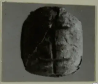 Glyptic find from Amathus: a rounded stone seal with engraved lines forming a cross-like pattern