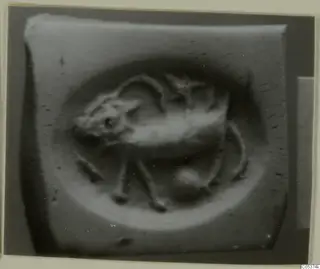 Close-up of a seal or gem with a raised animal figure within an oval field