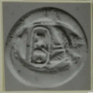 Glyptic: a round seal or gem with a raised rectangular motif and curved lines