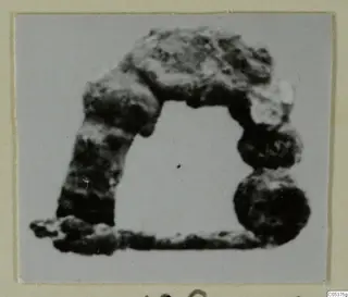 Corroded bronze loop from Amathus, with a flat bar along its base