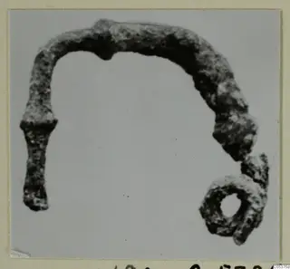 Corroded bronze object with a ring-shaped loop at one end, from Amathus