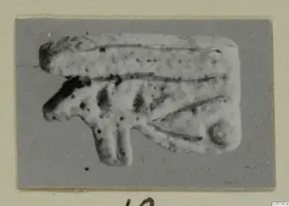 Eye-shaped pendant from Amathus, shown on a grey card mount
