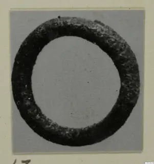 Silver ring with a thick, dark, pitted band, from Amathus