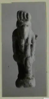 Small standing figurine with a ridged headdress and arms at its sides, from Amathus tombs