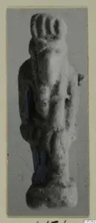 Small standing figurine from Amathus with traces of blue paint, photographed on a grey card mount