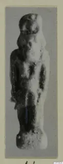 Small standing figurine from Amathus, photographed on a grey backing mounted on cream card.