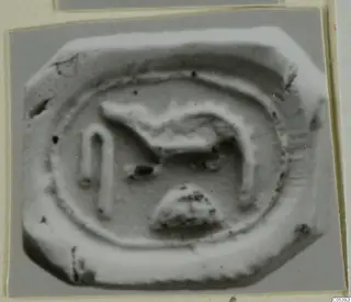 Glyptic find from Amathus: a stone seal with a raised animal-like figure, an arch and a rounded motif