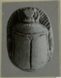 Scarab-shaped seal from Amathus, shown from its carved back with a raised top section and ridged edges