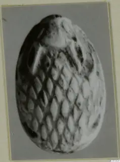 Oval stone scarab from Amathus with a raised diamond-lattice pattern across its back.