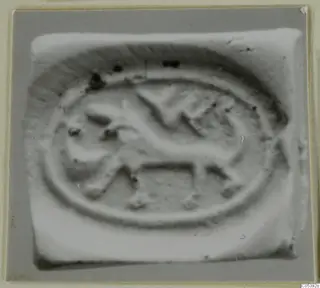 Oval seal impression from Amathus showing a four-legged animal inside a raised border