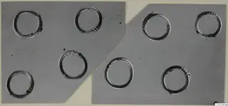 Eight rings with ridged edges laid out on a grey backdrop, from Marion tombs 46–60 finds