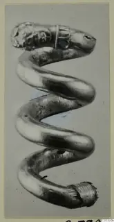 Coiled gold object with a decorated head and a blue inset, from Marion