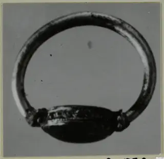 Ring with a thin closed hoop and an oval bezel, shown alone against a grey background