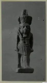 Small standing figure of Nefertum with a tall headdress, shown on a rectangular base