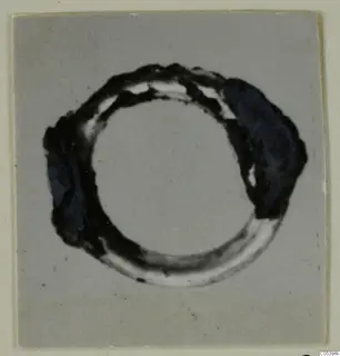 Bronze hair-ring from Marion, Tomb 38, shown on a grey card