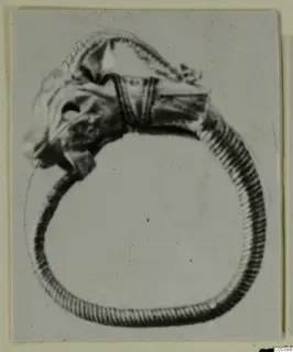 Figurine and ring from Marion: a hoop ring with a small figure projecting from its top