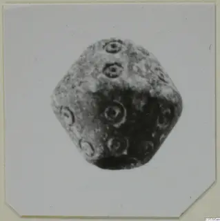 Stone object with many flat faces, each marked with concentric ring motifs, from Amathus