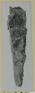 Corroded iron tool from Amathus, tapering to a point at the lower end.