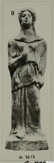 Figurine from Marion of a standing figure in a long garment with a raised hand