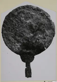 Bronze disc-shaped object with a short handle, Marion tombs 61–98, shown on a photo card