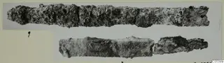 Two corroded iron tool fragments from Marion Tomb 27, shown on a mounted photograph
