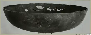 Wide open bowl from Marion with a dark surface and breaks along the far inner wall