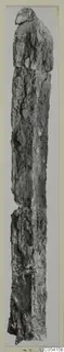 Long, narrow, weathered object from Amathus, photographed upright against a grey background.
