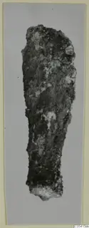 Corroded iron weapon fragment from Amathus tombs 1–9, long and narrow, tapering to a broken lower end