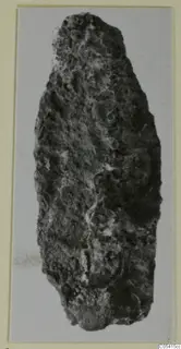 Corroded iron fragment, probably a weapon, from the Amathus tomb finds, shown as a photograph on a card mount
