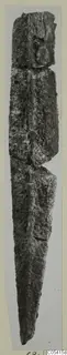 Heavily corroded metal sword or dagger from Amathus, tomb 2-26, photographed upright on a light grey background