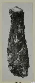 Corroded metal object from Amathus, tapering to a flat top, shown on a card mount