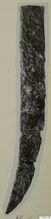 Corroded iron knife from Amathus, long and narrow with a curved, pointed end