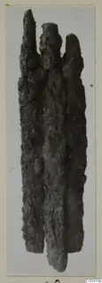 Heavily corroded iron weapon fragment from Amathus, shown upright on a mounted photograph.
