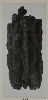 Corroded iron object from Amathus, elongated with a knobbed top and a ridged, crusted surface.