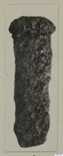 Iron tool from Amathus: a long, corroded object with a broader rounded head, shown on a pale card.