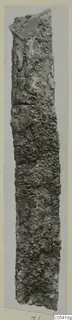 Corroded iron tool from Amathus, shown upright against a pale grey card mount.