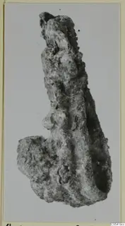 Heavily corroded iron object, long and narrow, from Amathus, shown against a pale background