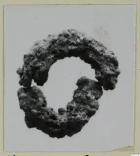 Corroded silver hair-ring from Marion, tombs 46–60, shown against a white background