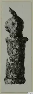 Corroded silver object with a knobbed top and cylindrical body, shown upright against a pale background.