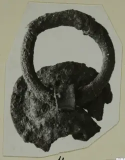 Corroded bronze ring and plate fragments from Marion Tomb 58, shown on a mounted photograph card