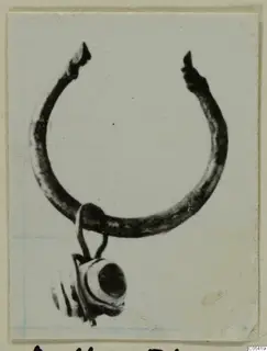 Silver ring with a banded bead hanging from its lower side, photographed on a card mount